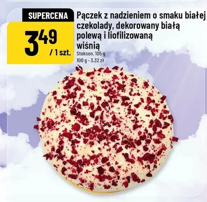 Pączek z nadzieniem o smaku białej czekolady, dekorowany białą polewą i liofilizowaną wiśnią promocja w POLOmarket